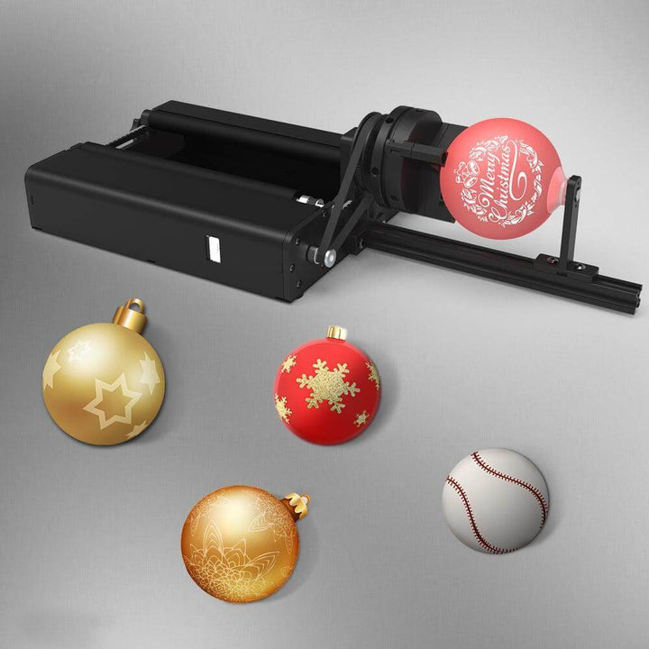 Black machine with Christmas ornaments and a baseball on a gray background Twotrees TR2 PRO Rotary Attachment for Laser Engraving | Twotrees Laser Engraver Parts Accessories