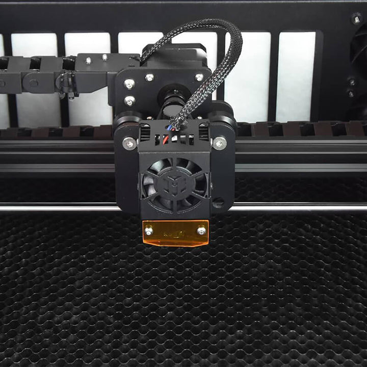 Close-up of a 3D printer's moving arm and print head on a textured black surface. Twotrees TS3 10W Blue Diode Enclosed Laser Engraver High Precision Laser Cutting and Engraving | Twotrees Laser Engraver